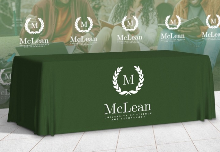 Green fabric table cover with a university logo